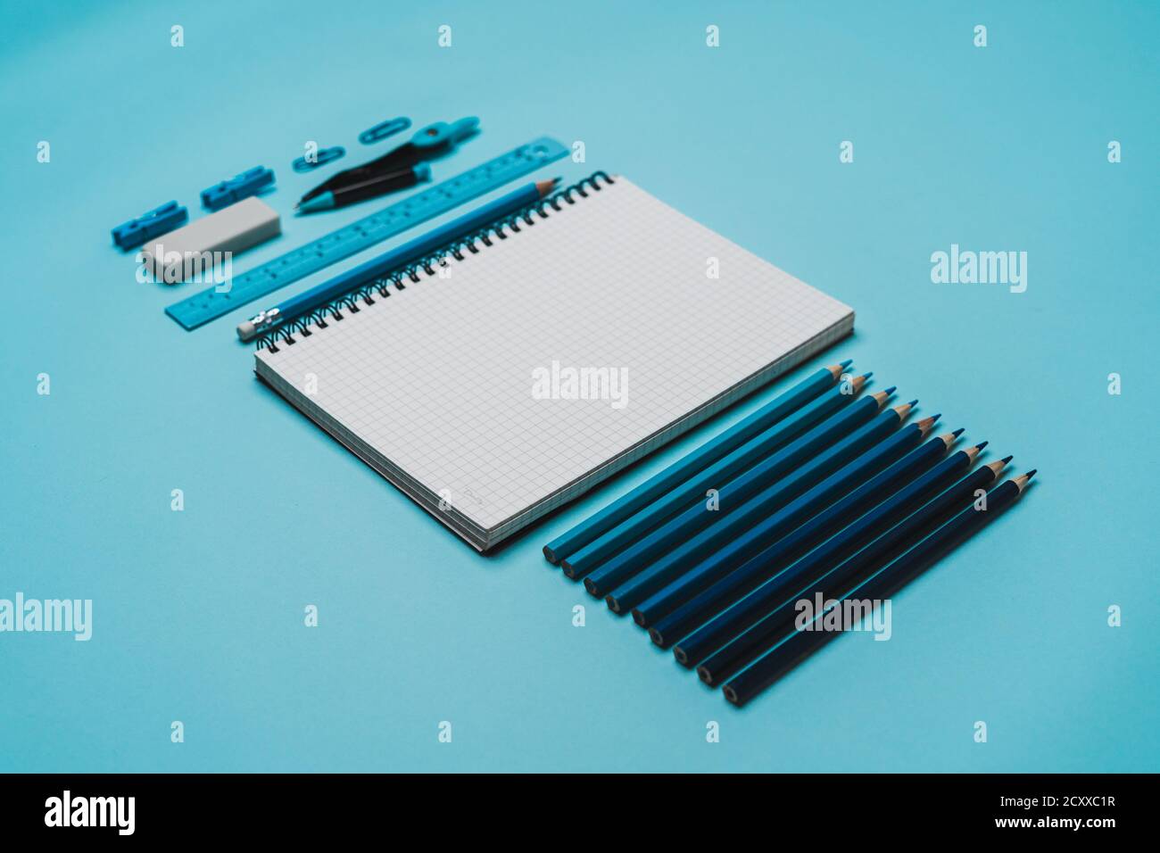 Stationery - book, pencil, ruler on a blue background Stock Photo - Alamy