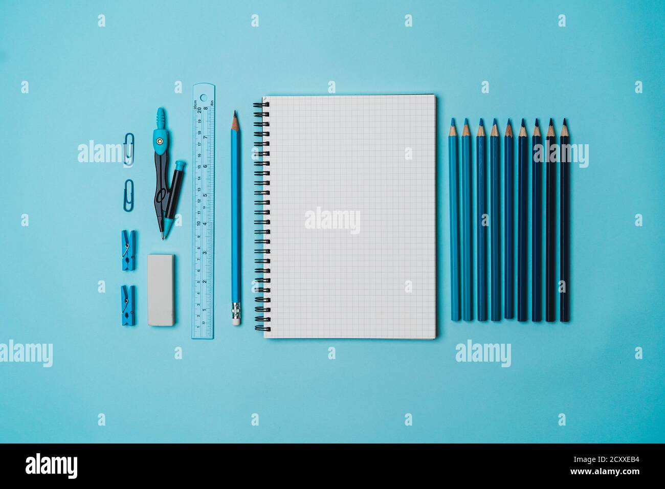 Stationery - book, pencil, ruler on a blue background Stock Photo - Alamy