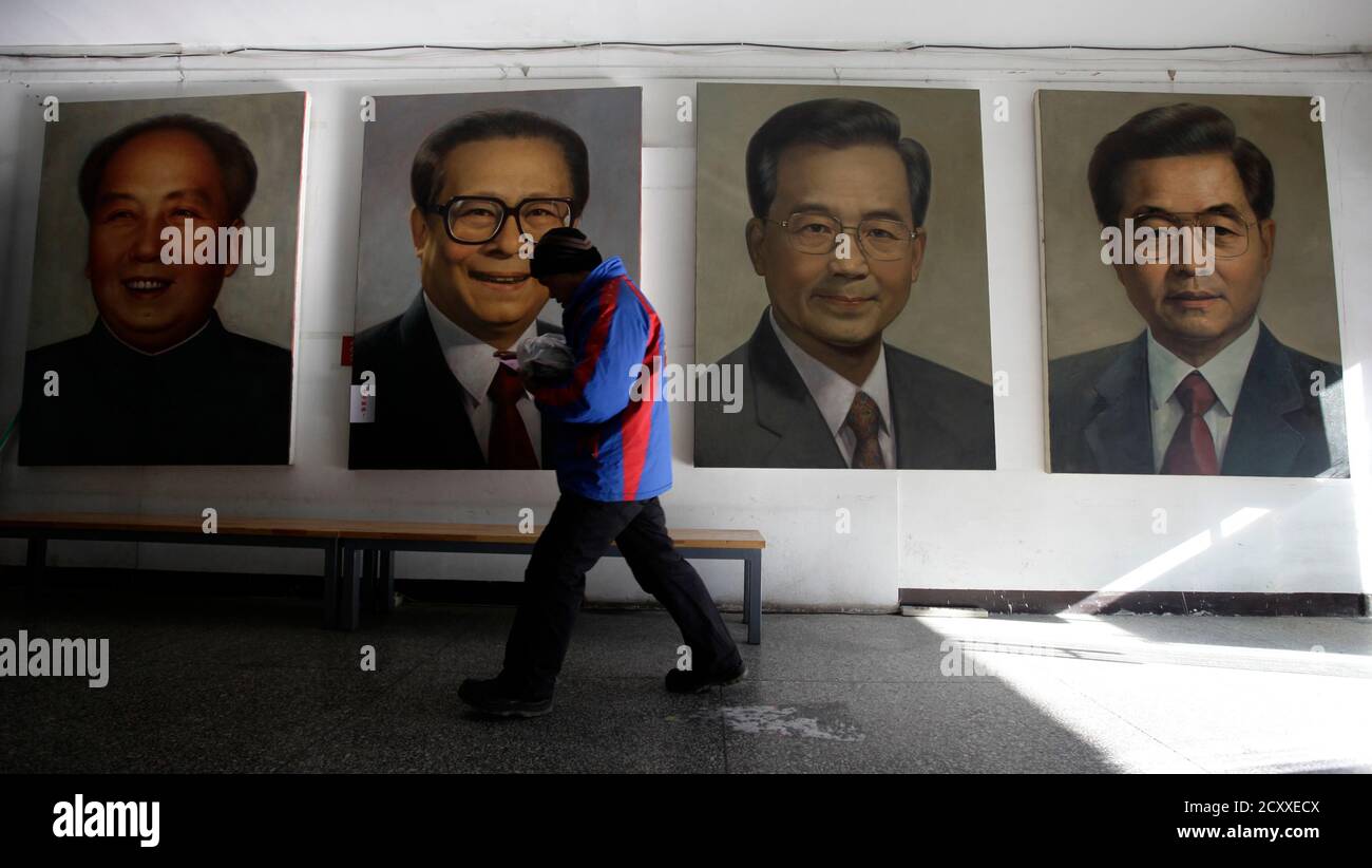 A man walks past portraits (R-L) of China's President Hu Jintao, Premier Wen Jiabao, former President Jiang Zemin and late Chairman Mao Zedong by Chinese artist Ye Zhifu outside a gallery in Beijing, January 18, 2011. Hu arrives in the United States on Tuesday for a four-day visit, with the centerpiece of the trip a formal state visit on Jan. 19 at the White House. REUTERS/Jason Lee(CHINA - Tags: POLITICS) Stock Photo