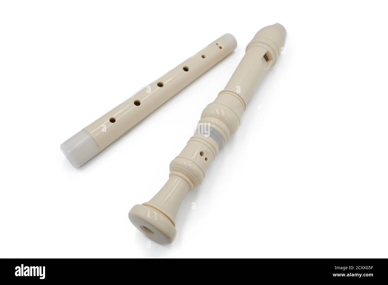 White flute recorder in two parts on a white isolated background, close
