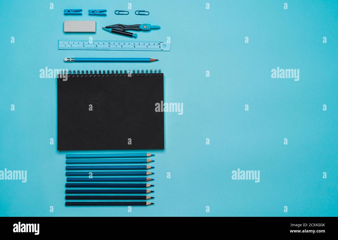 Stationery - book, pencil, ruler on a blue background Stock Photo - Alamy