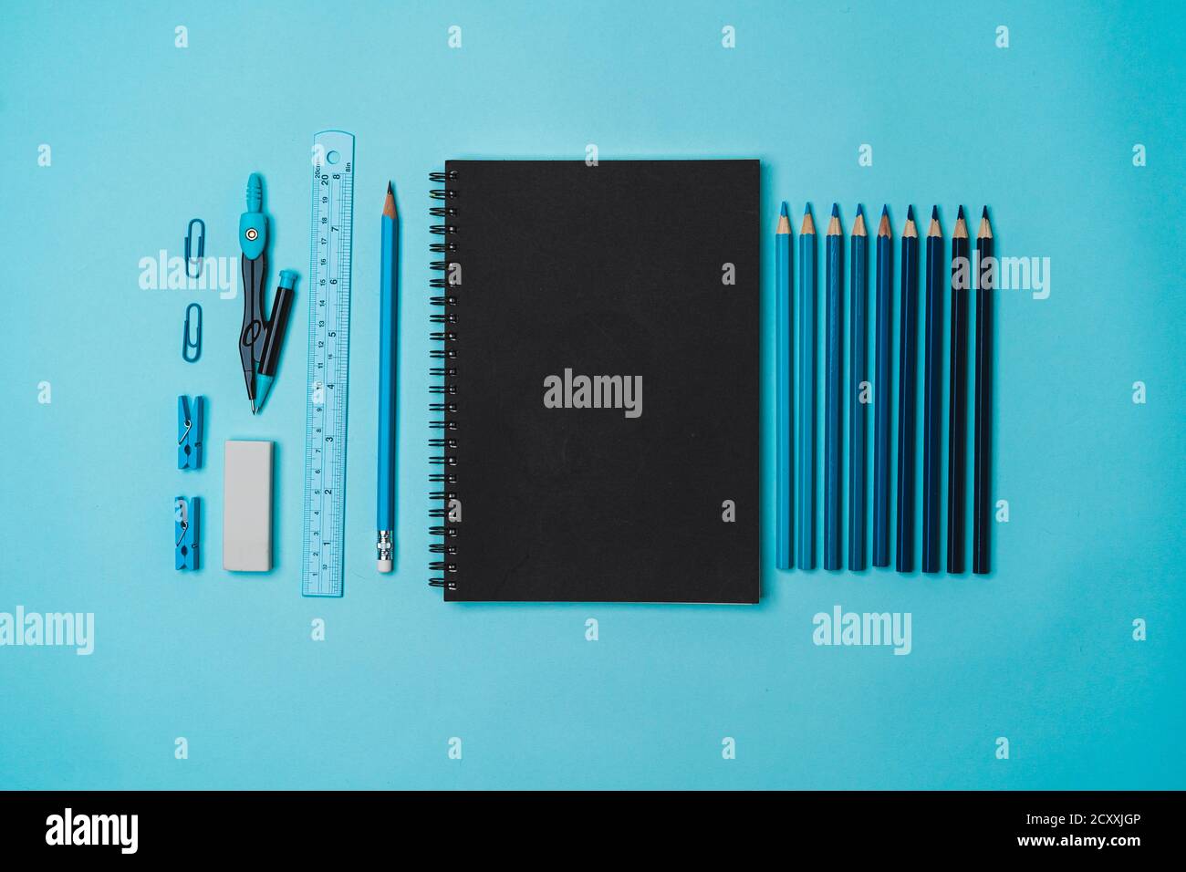 Stationery - book, pencil, ruler on a blue background Stock Photo - Alamy