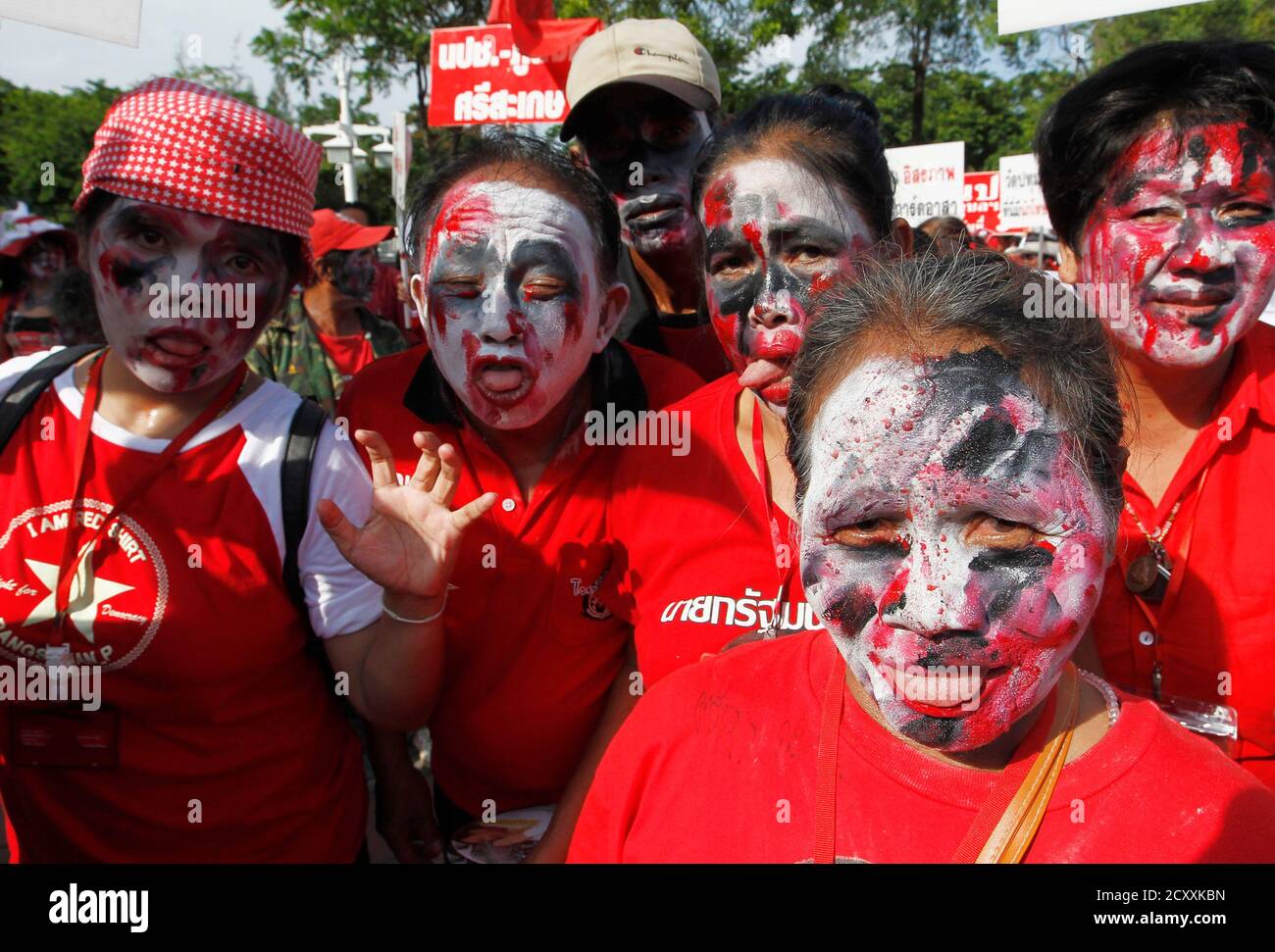 Red shirt supporters dress up as ghosts to mark the second anniversary of a government crackdown on red shirt protesters at Ratchaprasong intersection in Bangkok May 19, 2012. Red shirts gathered to mark the two year anniversary of a government crack down that left 91 people dead and over 2,000 injured. REUTERS/Sukree Sukplang (THAILAND - Tags: POLITICS CIVIL UNREST RELIGION) Stock Photo