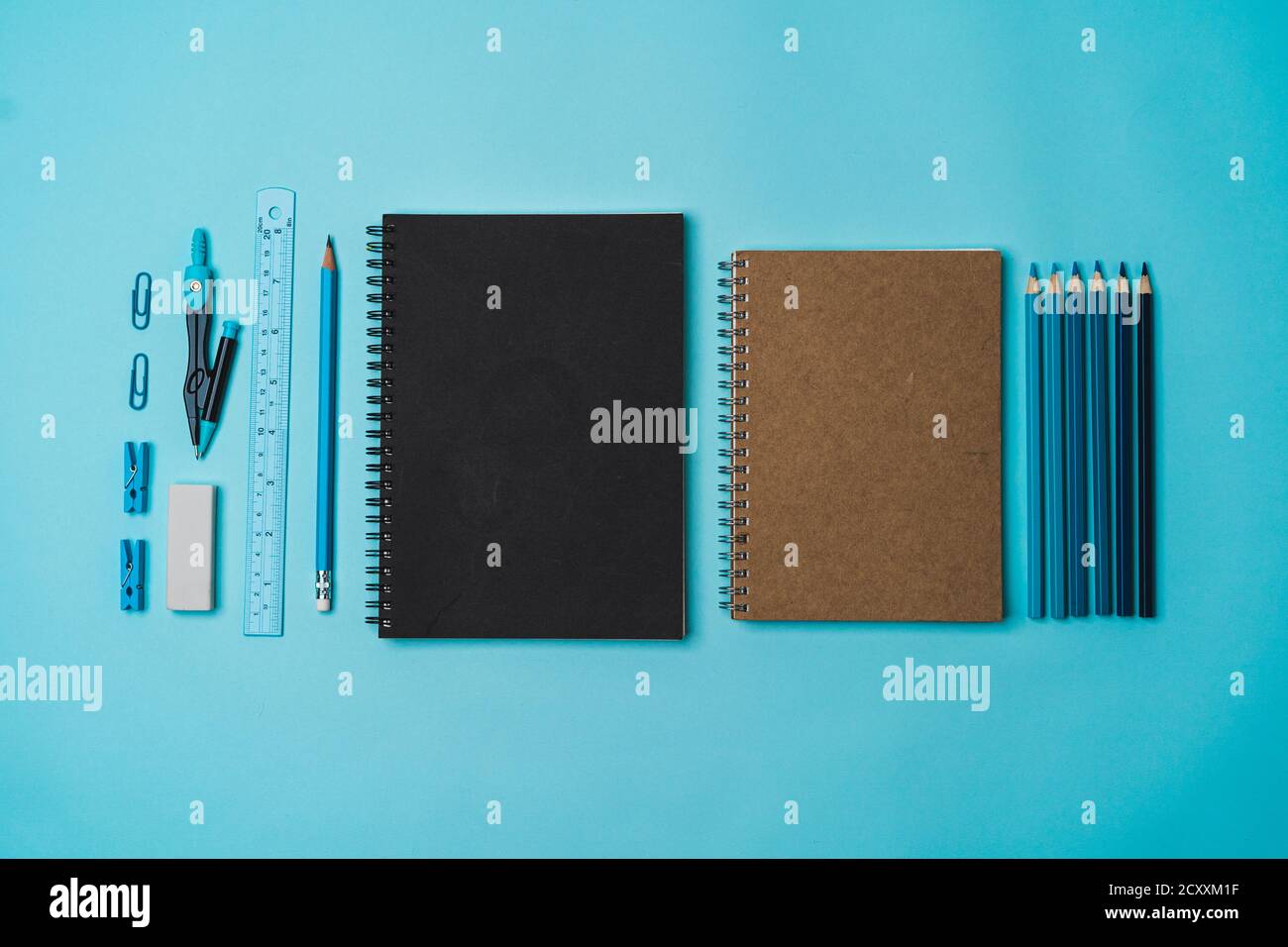 Stationery - book, pencil, ruler on a blue background Stock Photo - Alamy