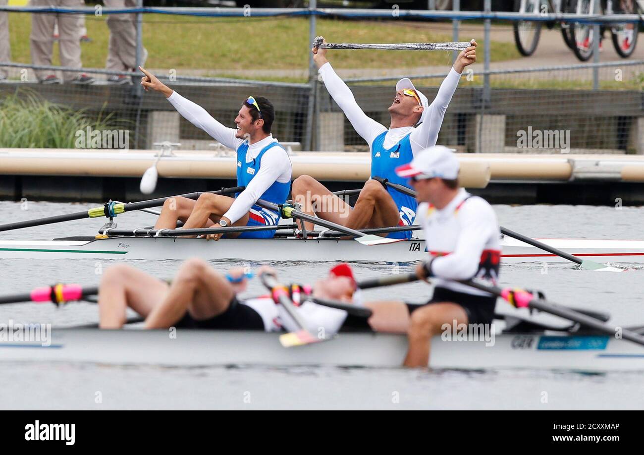 Italy's (rear) Alessio Sartori and Romano Battisti react after their men's double sculls semifinals at Eton Dorney during the London 2012 Olympic Games July 31, 2012. Germany's Stephan Krueger and Eric Knittel are in the foreground.   REUTERS/Jim Young (BRITAIN  - Tags: SPORT ROWING SPORT OLYMPICS) Stock Photo