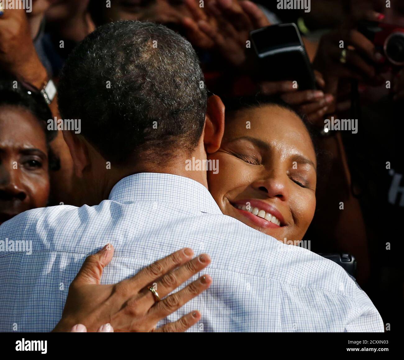A woman hugs U.S. President Barack Obama at a campaign event at the Palm Beach County Convention Center in Florida September 9, 2012.    REUTERS/Larry Downing  (UNITED STATES - Tags: POLITICS ELECTIONS) Stock Photo