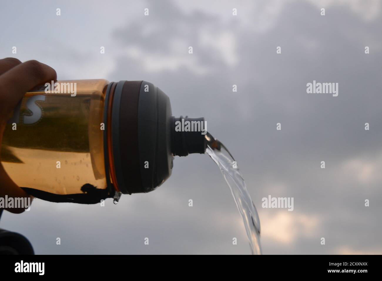 Water bottle with cloudy sky in the background Stock Photo Alamy
