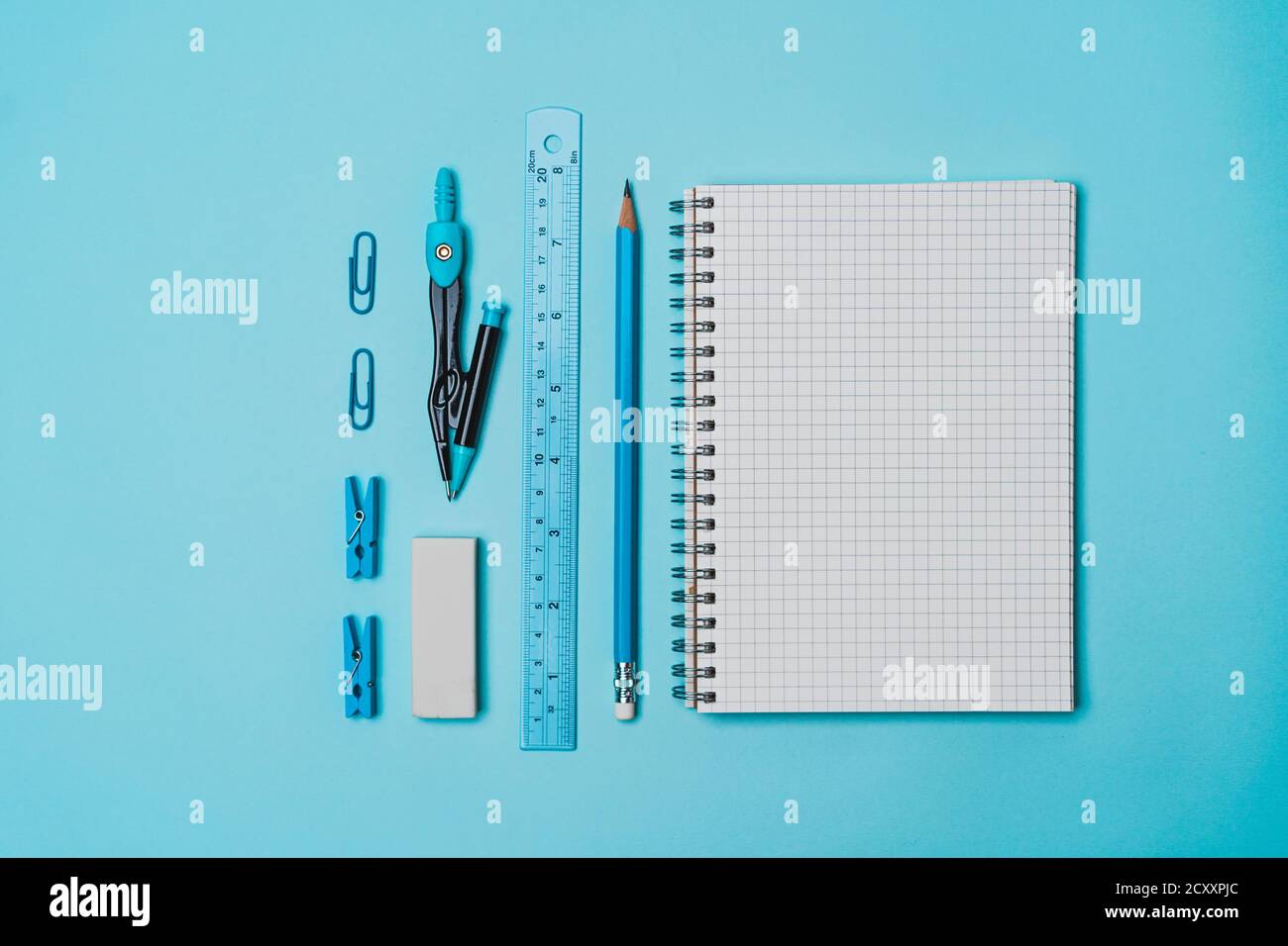 Stationery - book, pencil, ruler on a blue background Stock Photo - Alamy