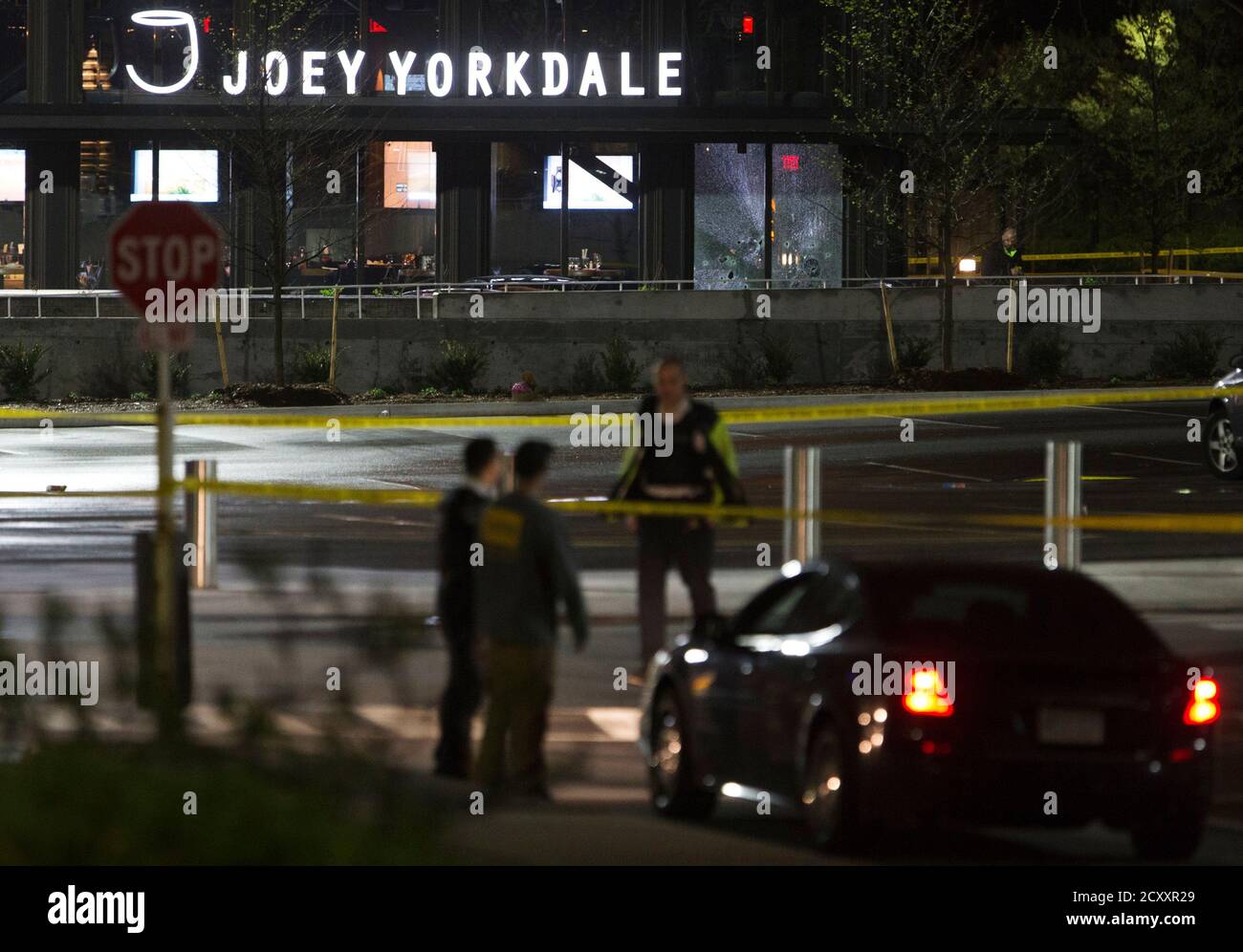 Security guards and police officers stand in front of the Joey Yorkdale restaurant where gunshots were fired at the Yorkdale shopping mall in Toronto May 11, 2013. One man has been sent to a local hospital with injuries following the incident, local media said.  REUTERS/Mark Blinch (CANADA - Tags: CRIME LAW BUSINESS) Stock Photo
