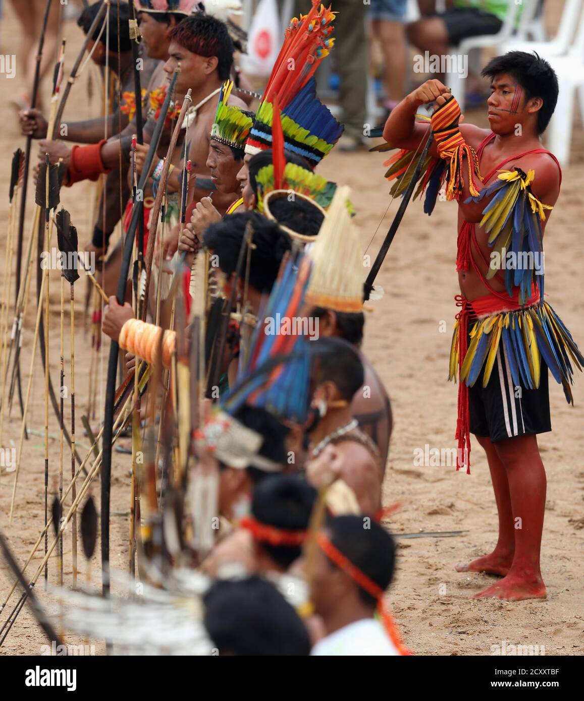 Members of Brazilian indigenous ethnic groups line up before the  bow-and-arrow competition during the XII Games of the Indigenous People, in  Cuiaba November 12, 2013. Forty eight Brazilian Indigenous tribes will  present
