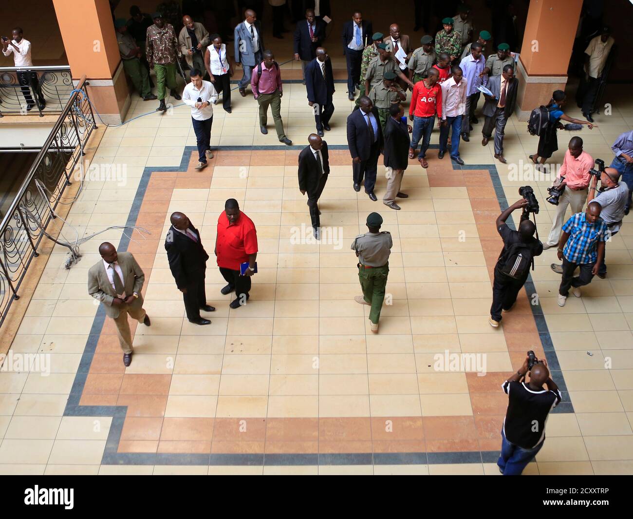 The four men (top R) charged with helping al Qaeda-linked militants launch an attack on the Westgate mall, are escorted by prison warders through the ground floor of the building during a court session in Nairobi January 21, 2014. The trial for the four Somali men, Mohamed Ahmed Abdi, Liban Abdullah Omar, Hussein Hassan, and Adan Mohamed Ibrahim, accused of giving support and shelter to gunmen who killed at least 67 people during the assault on Nairobi's Westgate complex that started on September 21, 2013, began last week. The assault was claimed by the Somali Islamist rebel group al Shabaab.  Stock Photo