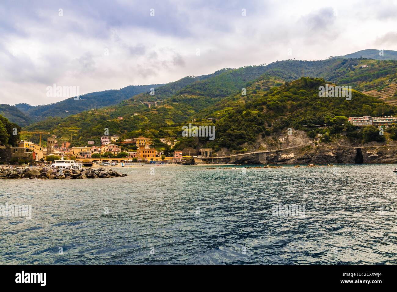 Gorgeous panoramic landscape view from the sea, overlooking the sand beach, the colourful buildings and the hillside of the old part of Monterosso al... Stock Photo