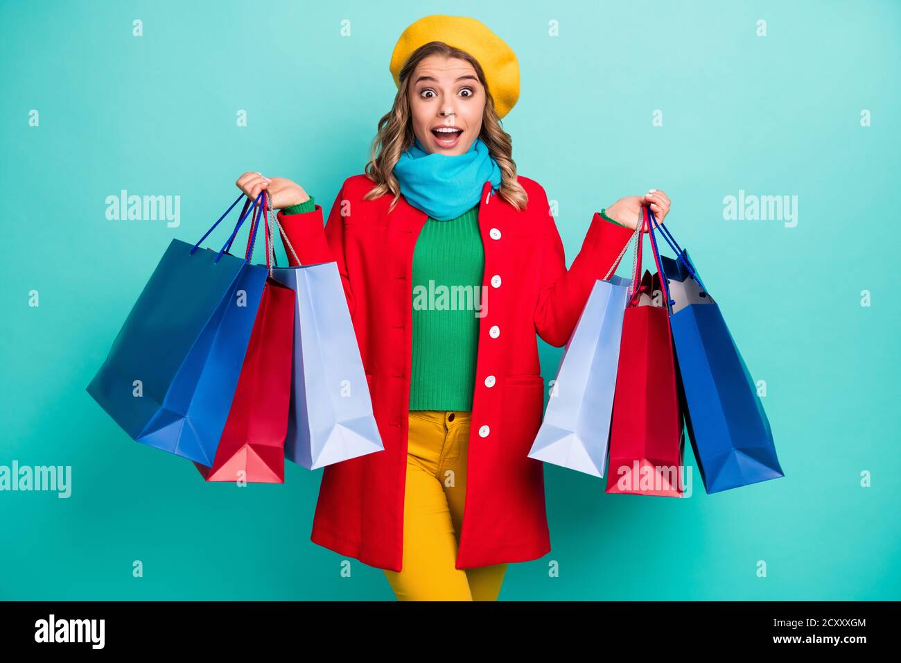 Astonished crazy girl impressed 50 off-sales buy all shopping center show  bags scream wow omg wear red green blue yellow sweater pants trousers Stock  Photo - Alamy