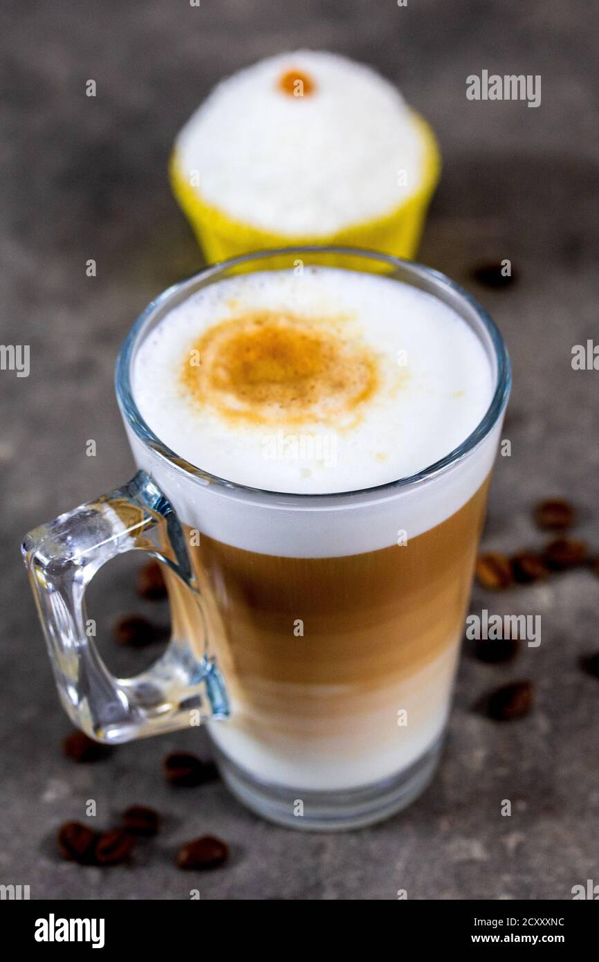 cupcake and cup of cappuccino on a table Stock Photo - Alamy