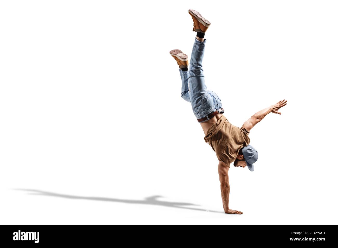 Young fit man in jeans performing a one hand stand isolated on white background Stock Photo