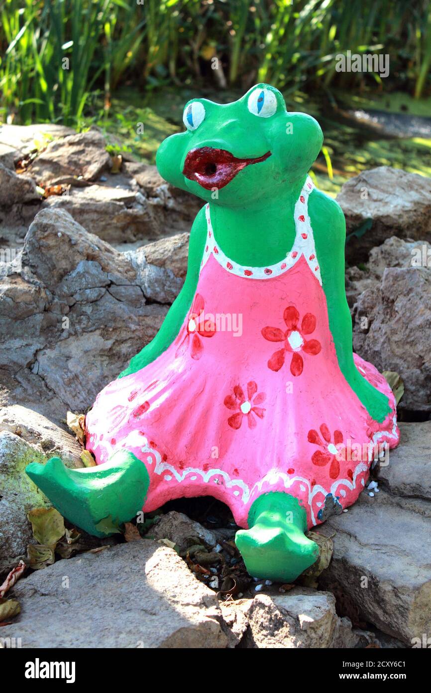 Kazan, Russia, 09.05.2020 Figure of a frog in a pink dress in a garden decor Stock Photo