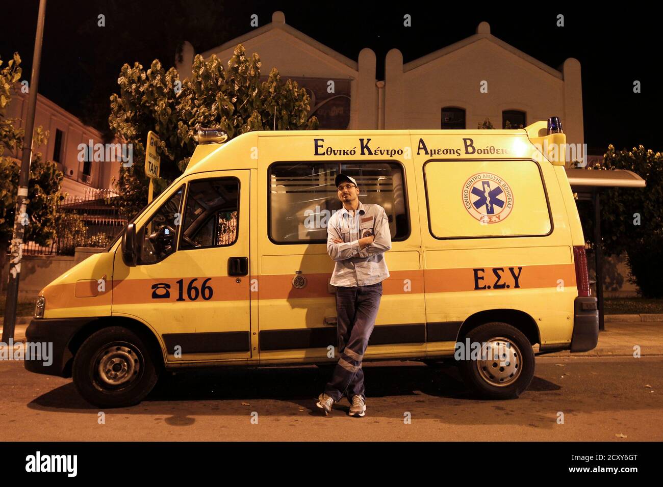 Panagiotis Schinas, 38, a rescuer of the Greek National Centre of First  Aid, poses in front of an ambulance in Athens May 28, 2012. Greece's  rundown state hospitals are cutting off vital