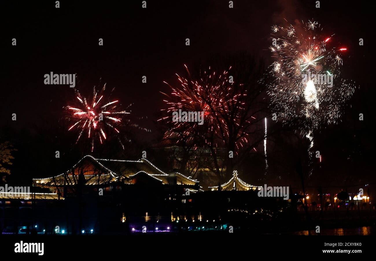 Fireworks explode over the Houhai lake as residents celebrate the ...