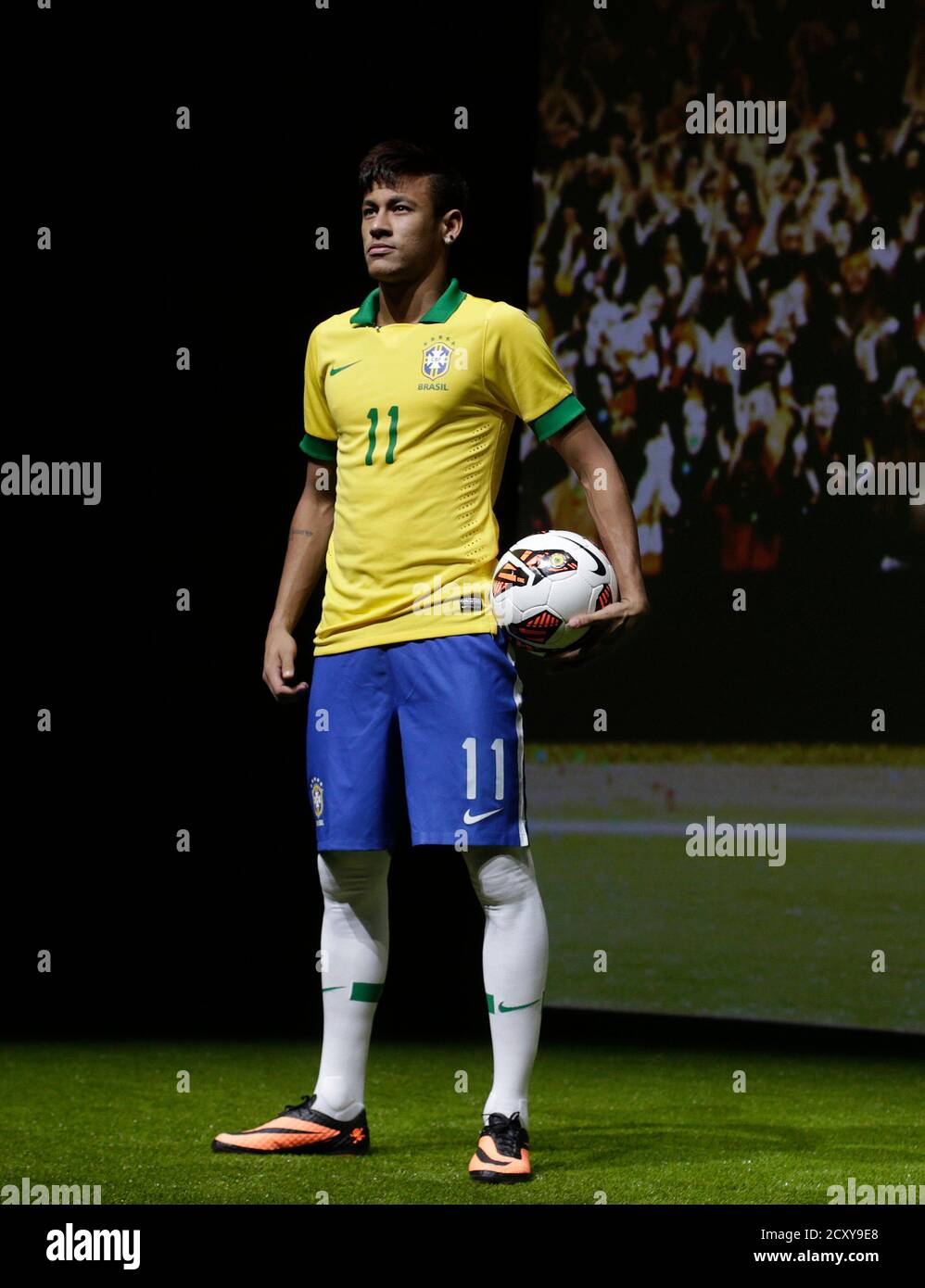 Brazilian soccer player Neymar wearing Nike's new Hypervenom soccer boots  presents them during their launch ceremony in Rio de Janeiro May 28, 2013.  Brazil's gifted World Cup hope Neymar is moving to