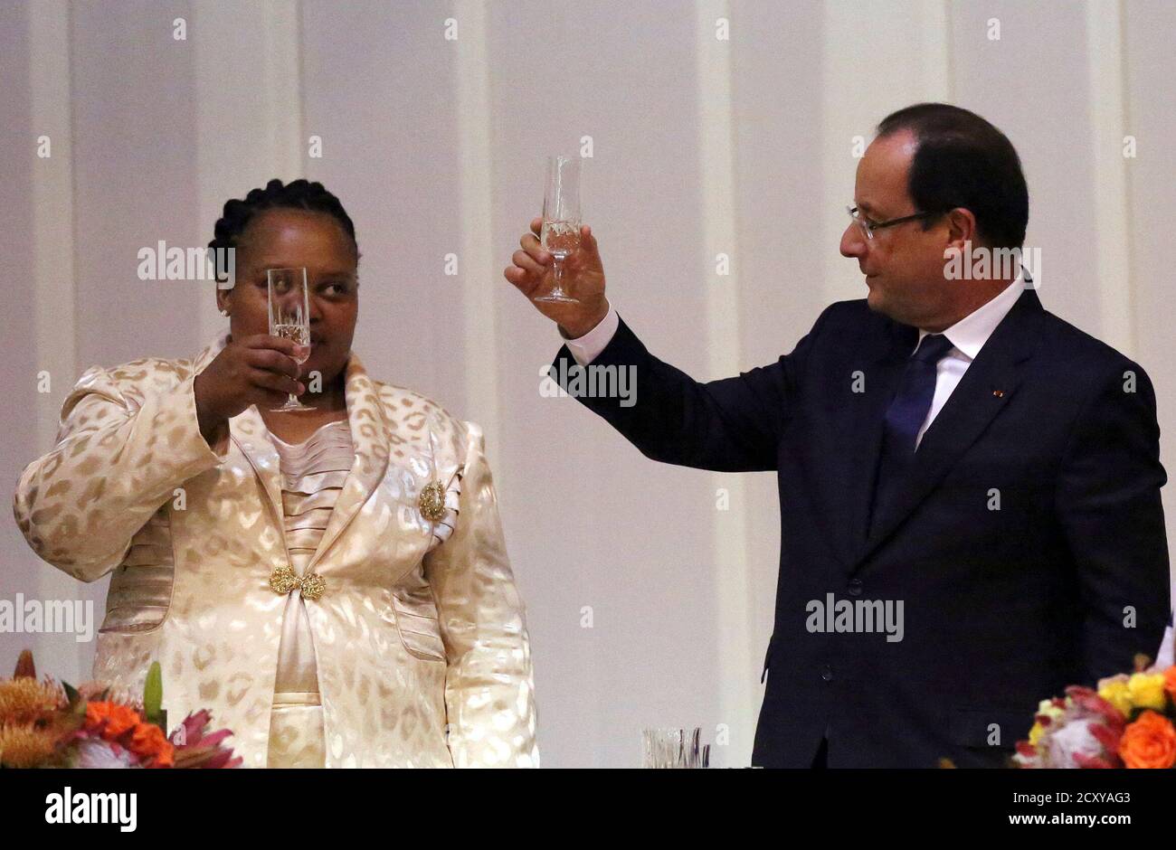 South Africa's First Lady Nompumelelo Zuma (L) and France's President Francois Hollande toast during a gala dinner at the State Guest House in Pretoria October 14, 2013. France will lend 100 million euros ($135 million) to South African state power utility Eskom to help it finance solar power projects in Africa's largest economy, according to a communique obtained by Reuters on Monday. The deal will be signed as a part of a summit between Hollande and South Africa's President Jacob Zuma, which started on Monday in Pretoria. REUTERS/Siphiwe Sibeko (SOUTH AFRICA - Tags: POLITICS BUSINESS ENERGY) Stock Photo