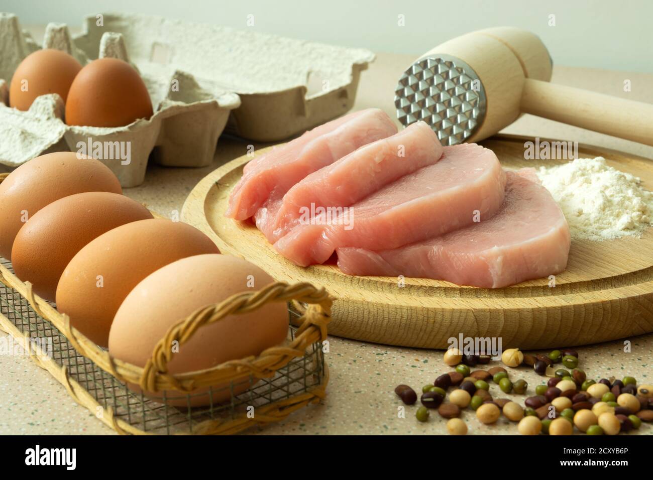 Pork loin on a board, flour, eggs and spices Stock Photo