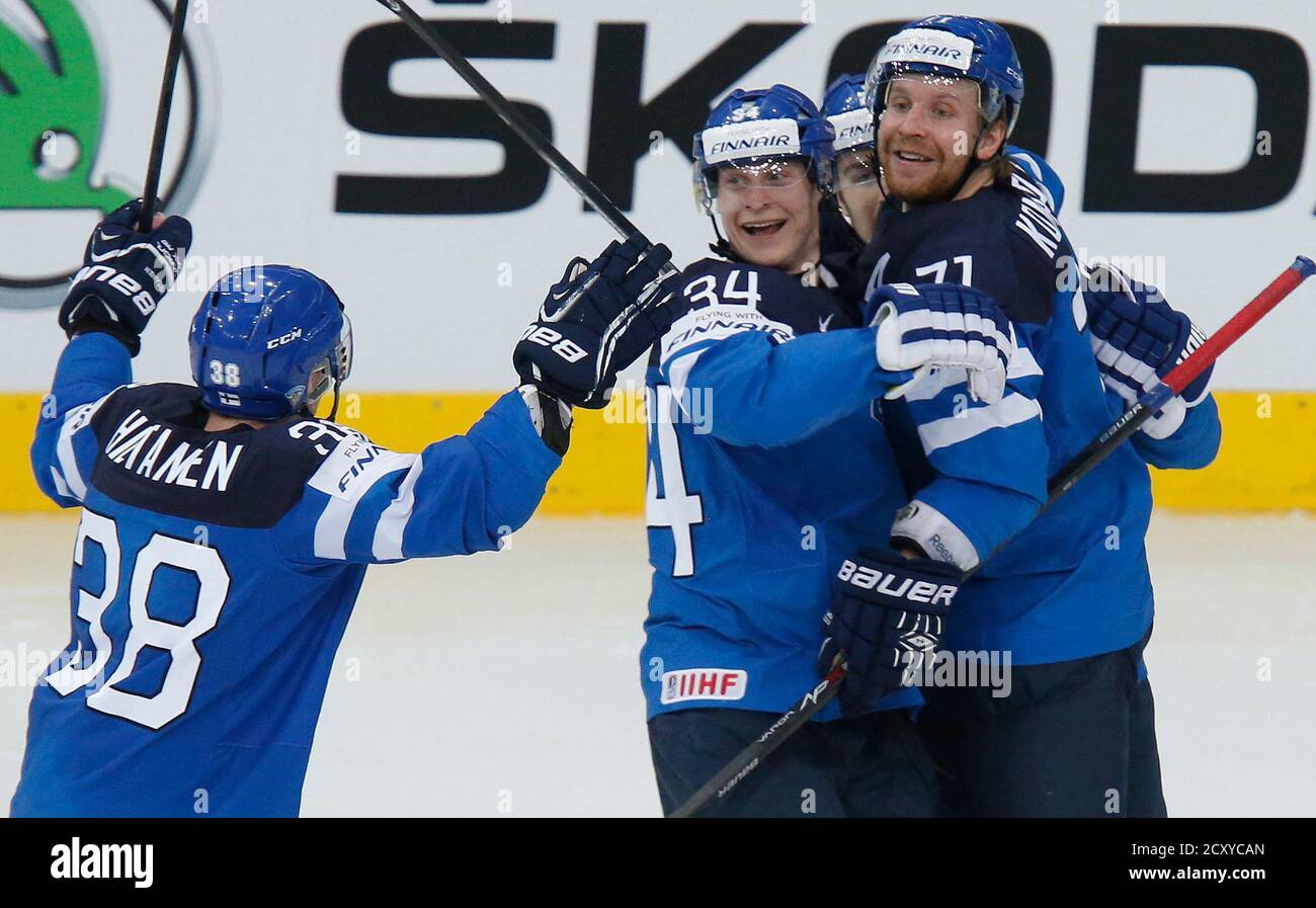 Finland's Olli Palola (2nd L) celebrates his goal against Russia with his  team mates Juuso Hietanen (L) and Leo Komarov (R) during the second period  of their men's ice hockey World Championship