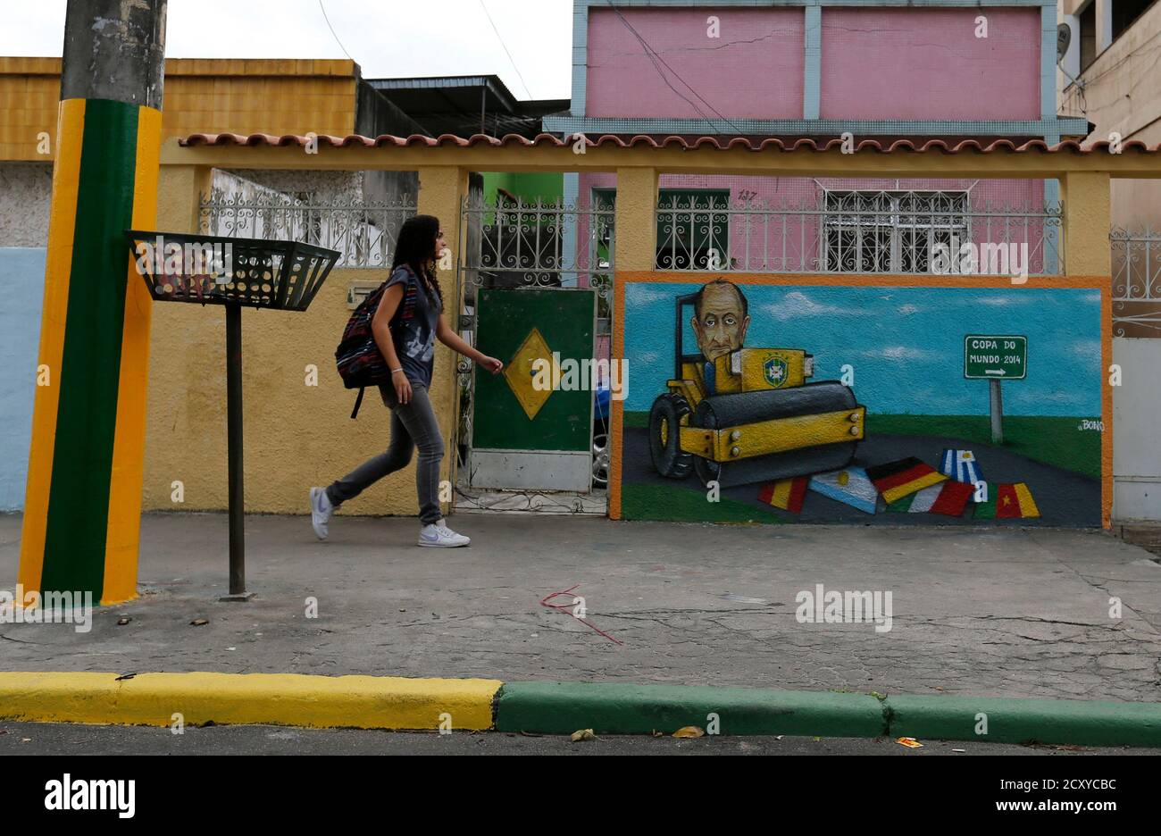 A Resident Walks Past Graffiti Referencing The 14 World Cup On Taturana Street At Vicente De Carvalho Neighborhood In Rio De Janeiro May 27 14 Rio De Janeiro Is One Of The
