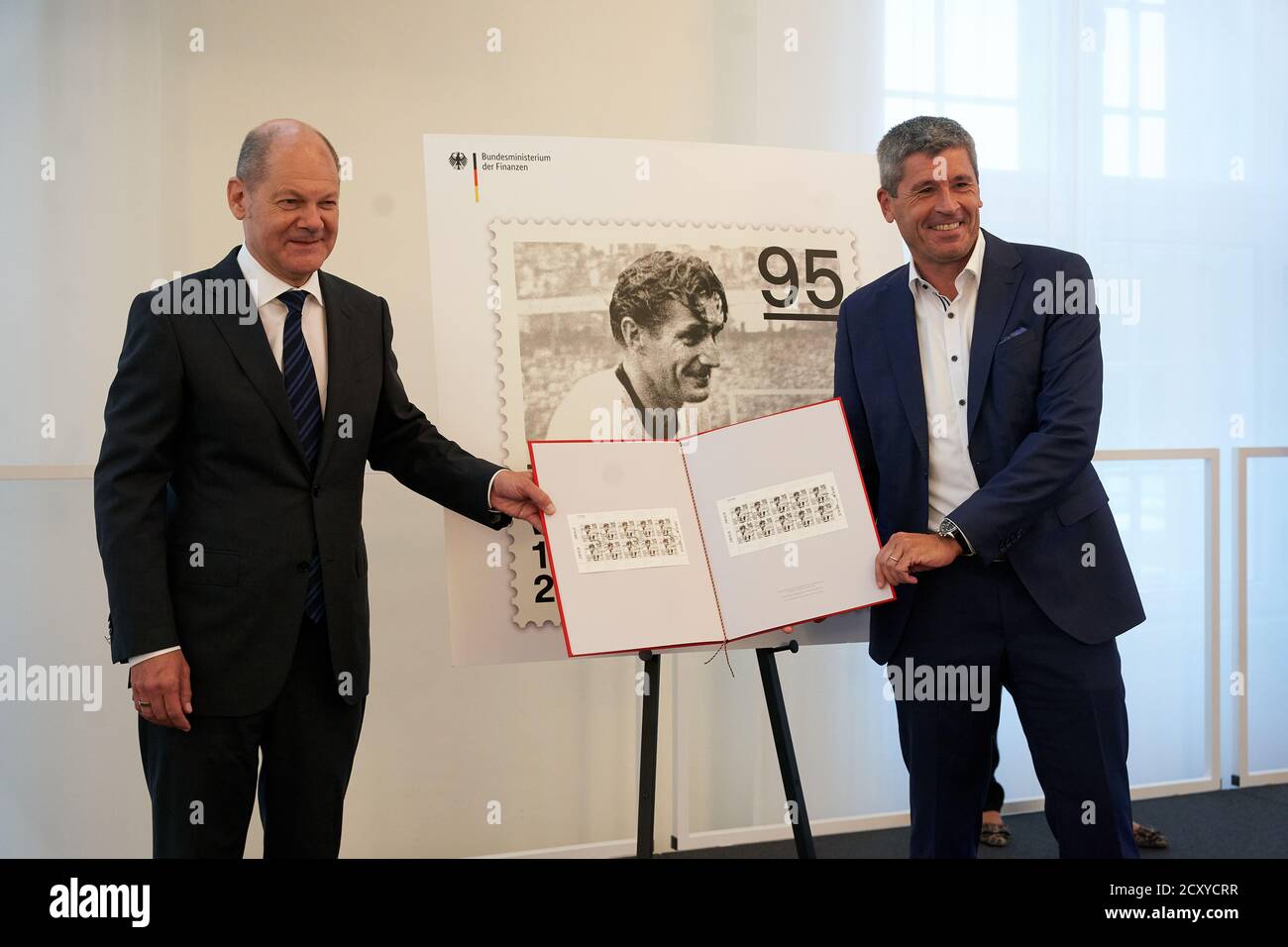 Mainz, Germany. 01st Oct, 2020. Federal Minister of Finance Olaf Scholz  (SPD, l) and the 1st Chairman of the 1st FC Kaiserslautern, Markus Merk,  present a stamp to mark the 100th birthday