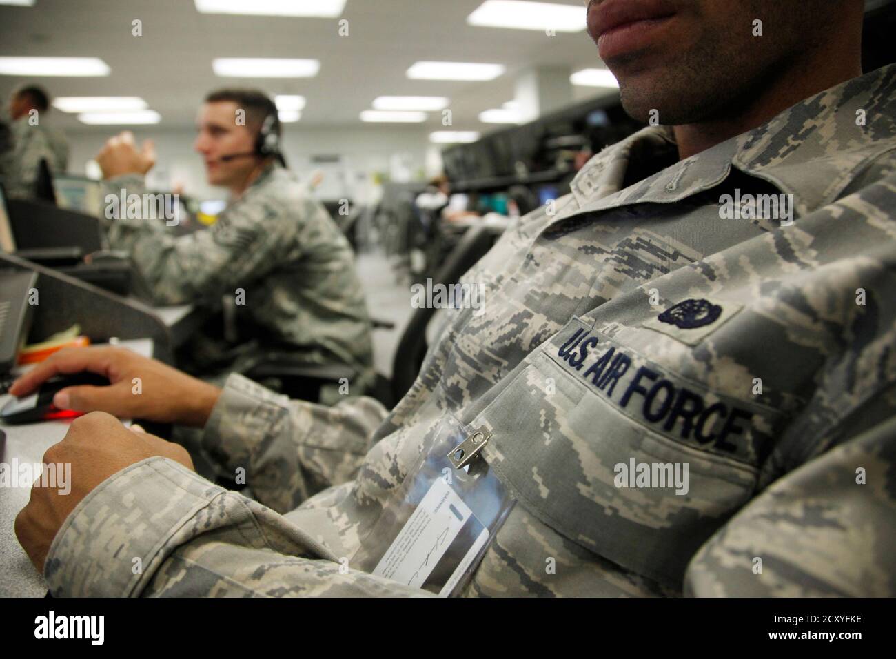 Personnel work at the Air Force Space Command Network Operations & Security Center at Peterson Air Force Base in Colorado Springs, Colorado July 20, 2010. U.S. national security planners are proposing that the 21st century's critical infrastructure -- power grids, communications, water utilities, financial networks -- be similarly shielded from cyber marauders and other foes. The ramparts would be virtual, their perimeters policed by the Pentagon and backed by digital weapons capable of circling the globe in milliseconds to knock out targets.  To match Special Report  USA-CYBERWAR/          RE Stock Photo
