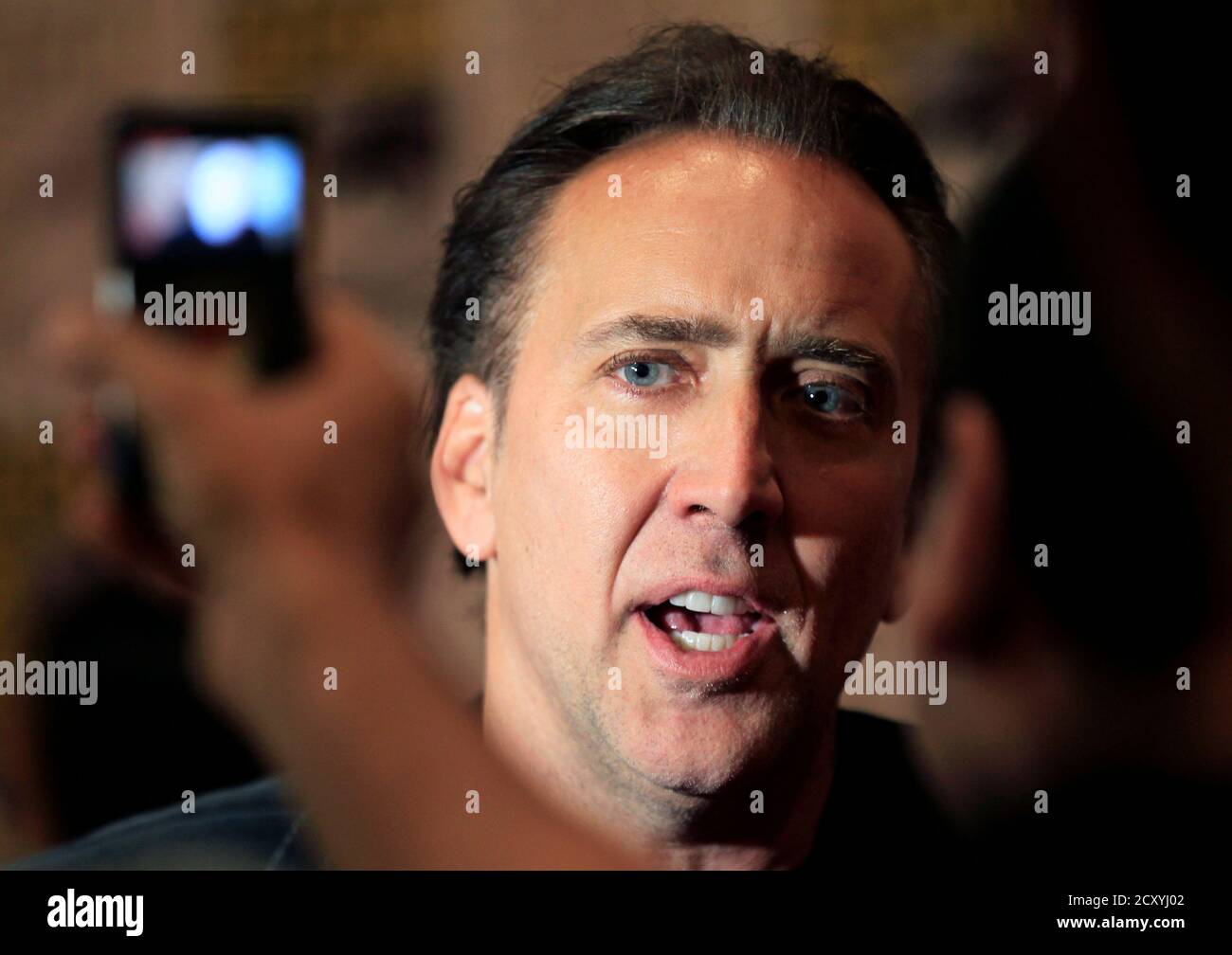Actor Nicolas Cage is interviewed at Comic Con as he promotes his movie Ghost Rider 'Spirit of Vengeance' at the pop culture event in San Diego, California July 22, 2011.   REUTERS/Mike Blake  (UNITED STATES - Tags: ENTERTAINMENT SOCIETY PROFILE) Stock Photo