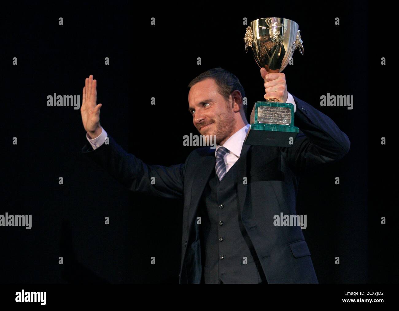 Actor Michael Fassbender receives the Coppa Volpi for Best Actor for his movie 'Shame' during the closing ceremony of the 68th Venice Film Festival September 10, 2011.REUTERS/Alessandro Bianchi (ITALY - Tags: ENTERTAINMENT) Stock Photo