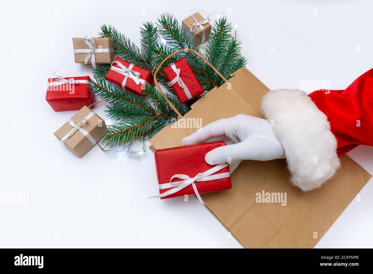 Hand of Santa Claus holds gift on the white background Stock Photo - Alamy