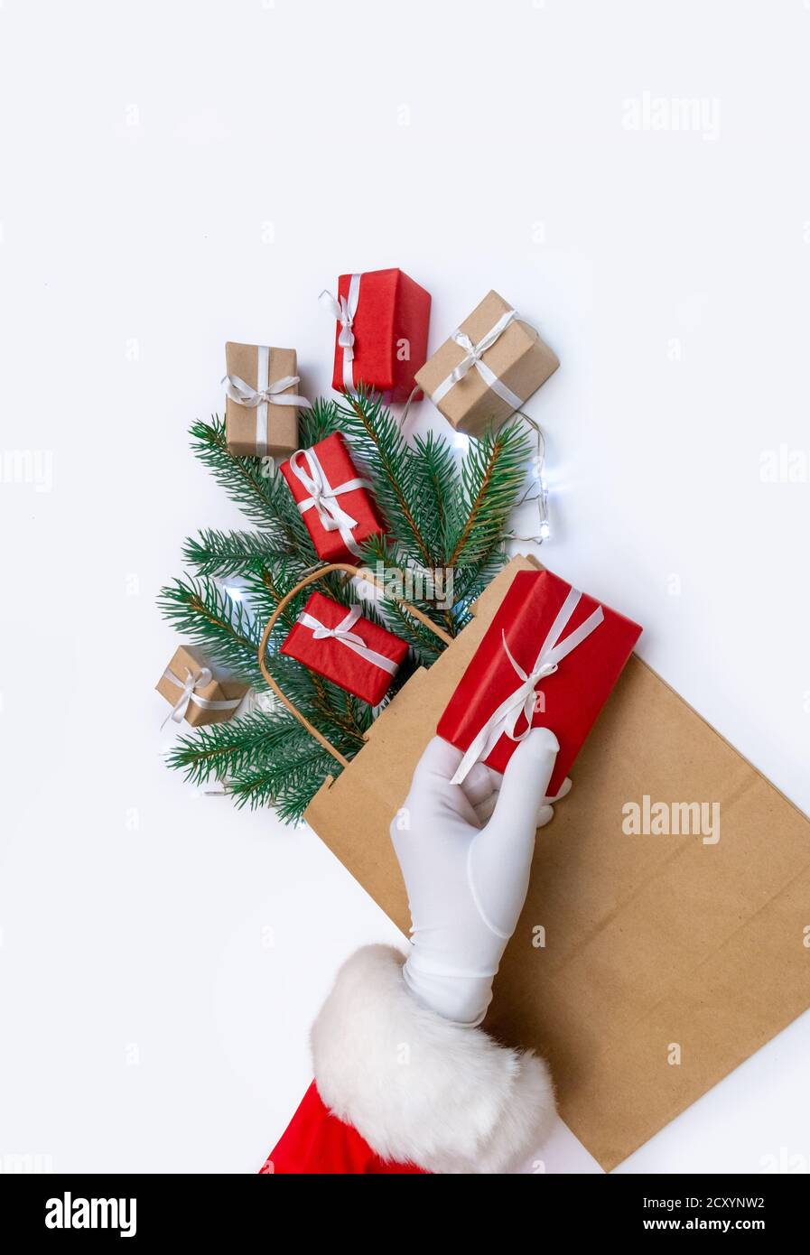 Hand of Santa Claus holds gift on the white background Stock Photo - Alamy