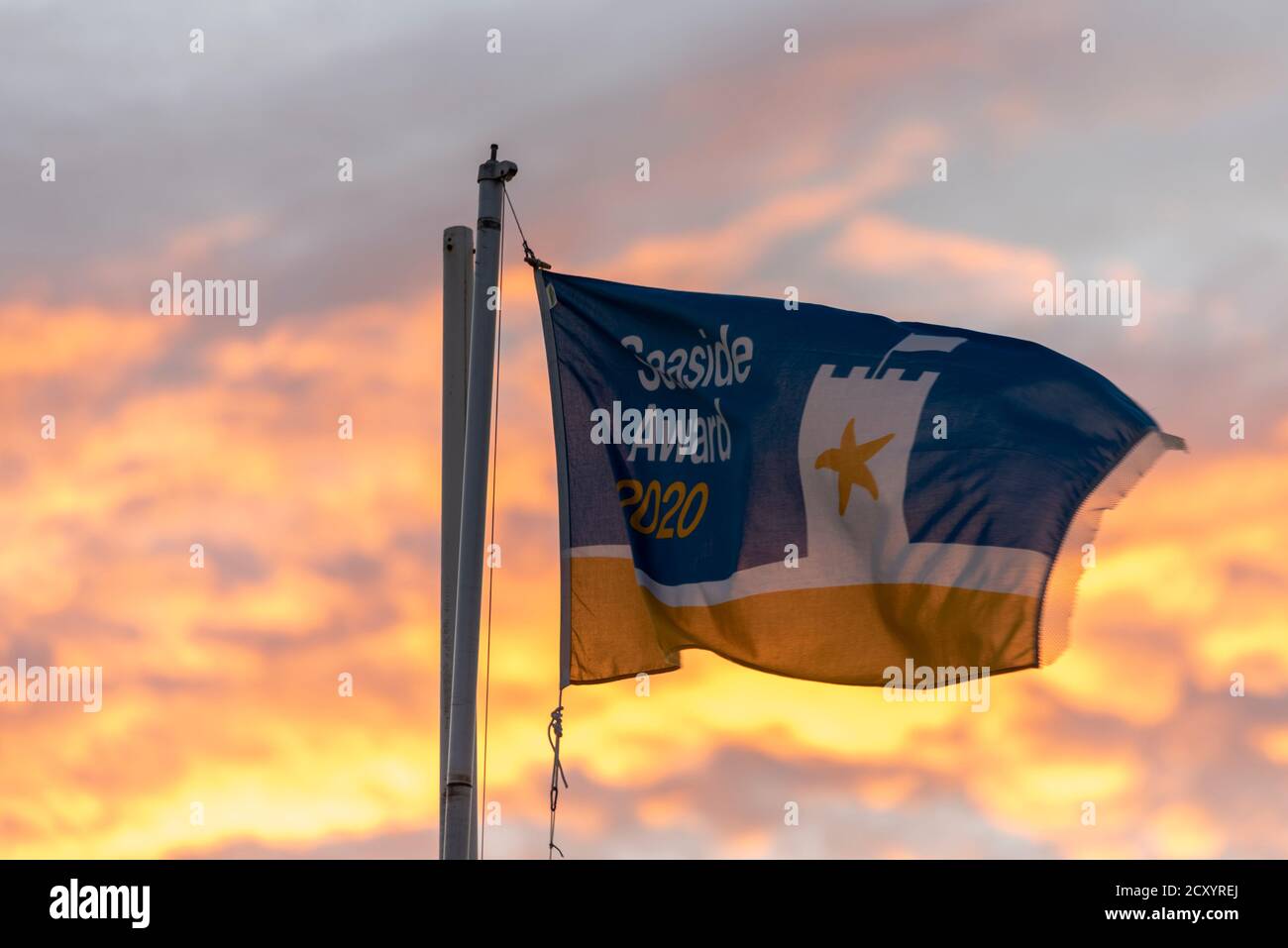 Seaside award 2020 flag flying at sunset at Southend on Sea, Essex, UK. Formerly called the Quality Coast Award Stock Photo