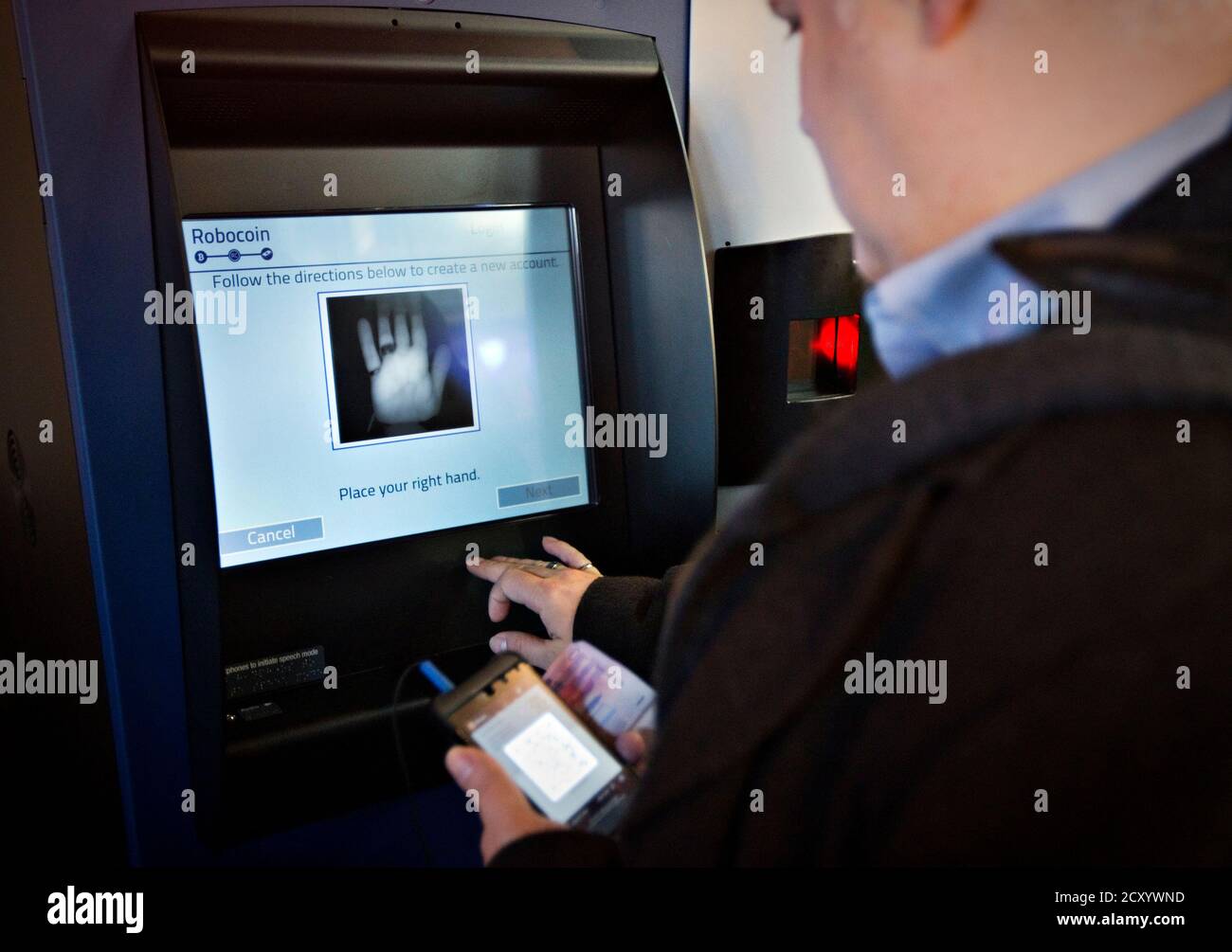 A Customer Registers His Hand Print Before Proceeding On The World S First Ever Permanent Bitcoin Atm Unveiled At A Coffee Shop In Vancouver British Columbia October 29 2013 The Kiosk Built By