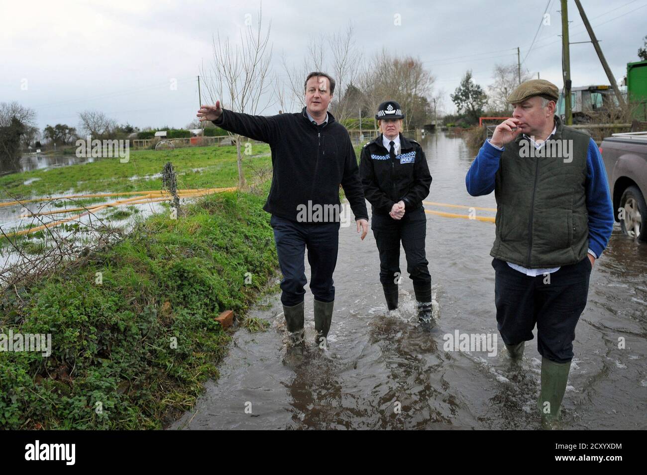Britain's Prime Minister David Cameron (L) with Bridgwater and West Somerset MP Ian Liddell-Grainger (R) during a visit to flood affected areas at Goodings Farm in Fordgate, Somerset February 7, 2014. REUTERS/Tim Ireland/Pool (BRITAIN - Tags: ENVIRONMENT DISASTER POLITICS) Stock Photo