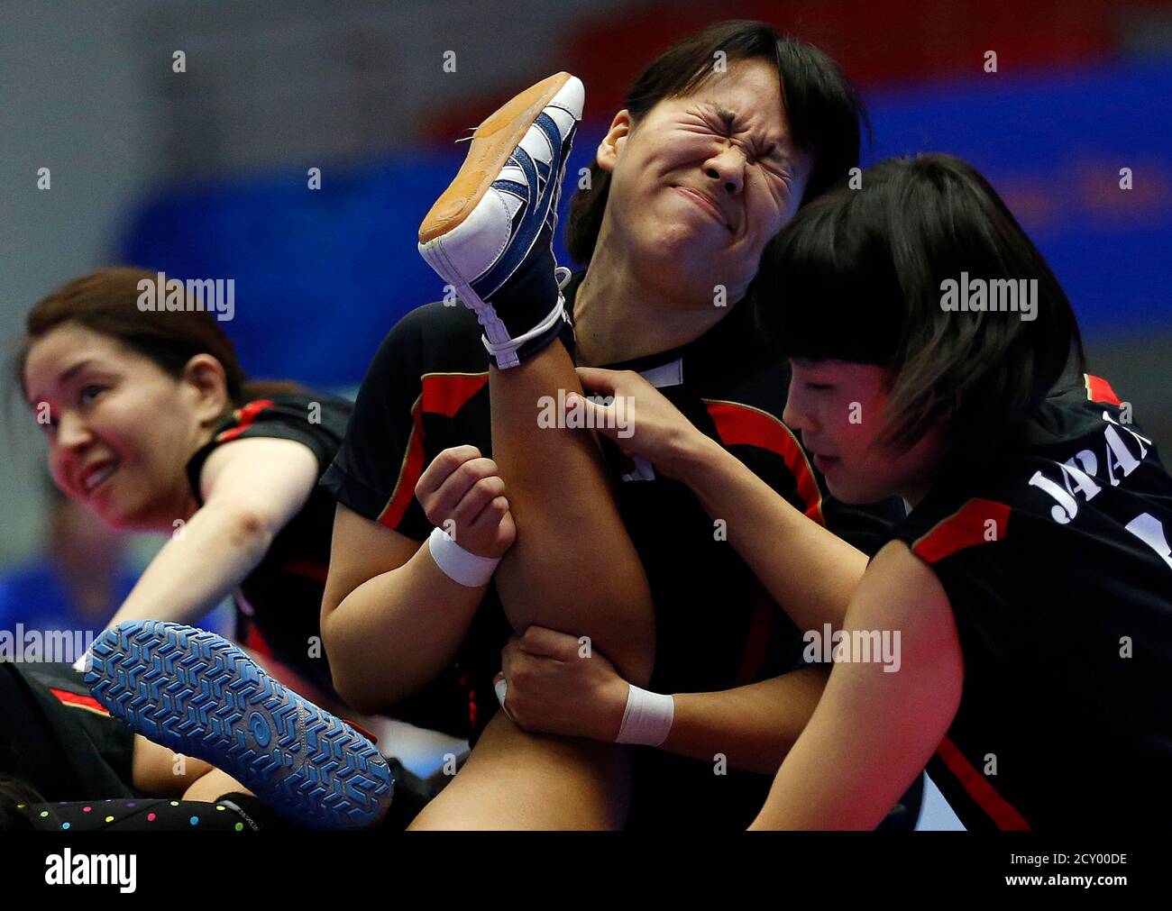 Japan's Yumi Kaneko, Eri Kasahara and Miho Echizenya (L-R) tackle a Thai player during their women's preliminary kabaddi match in the Songdo Global University Gymnasium at the 17th Asian Games in Incheon September 29, 2014.  REUTERS/Olivia Harris (SOUTH KOREA - Tags: SPORT TPX IMAGES OF THE DAY) Stock Photo