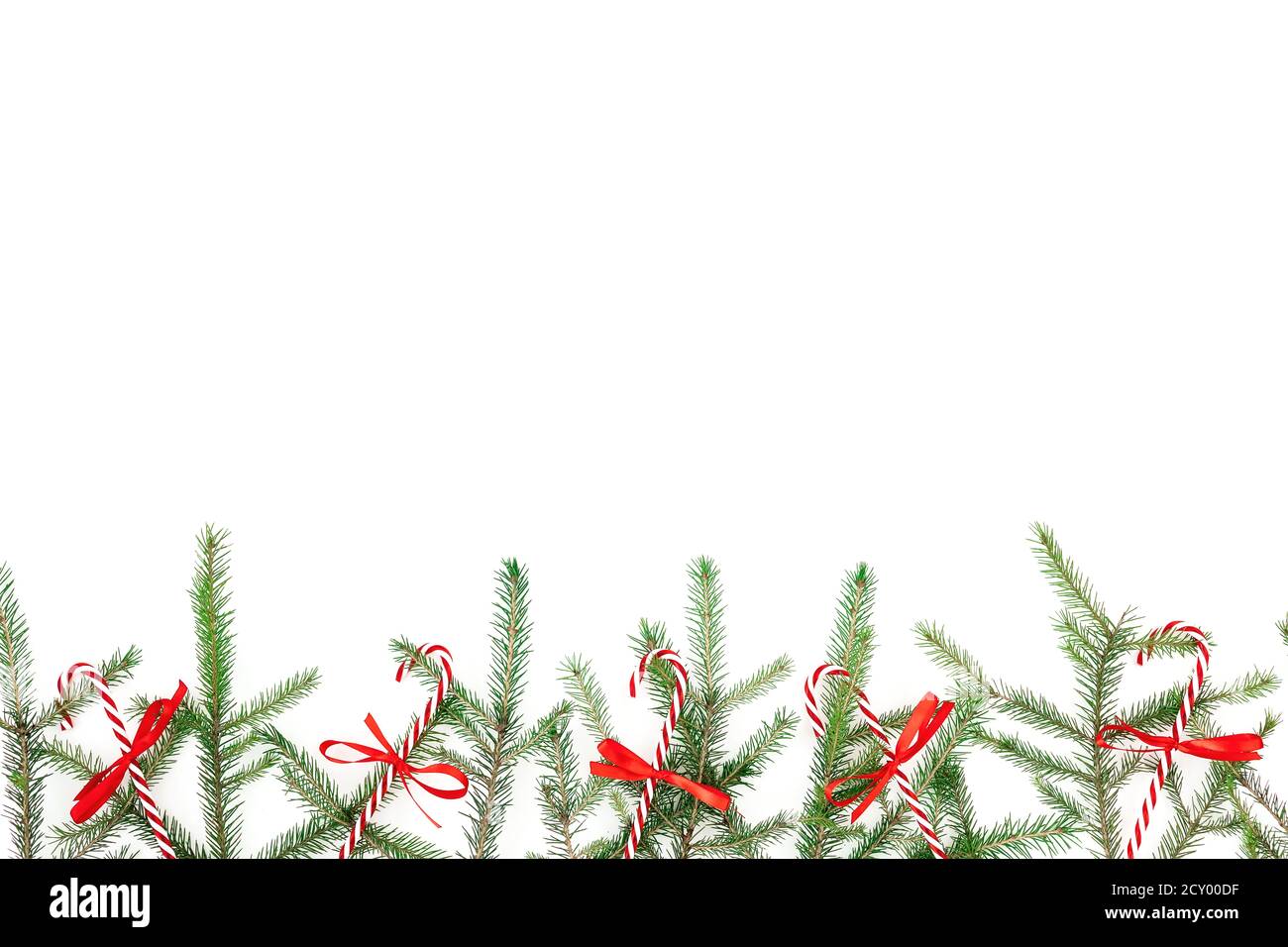 Christmas frame made of fir branches and red decoration on white ...