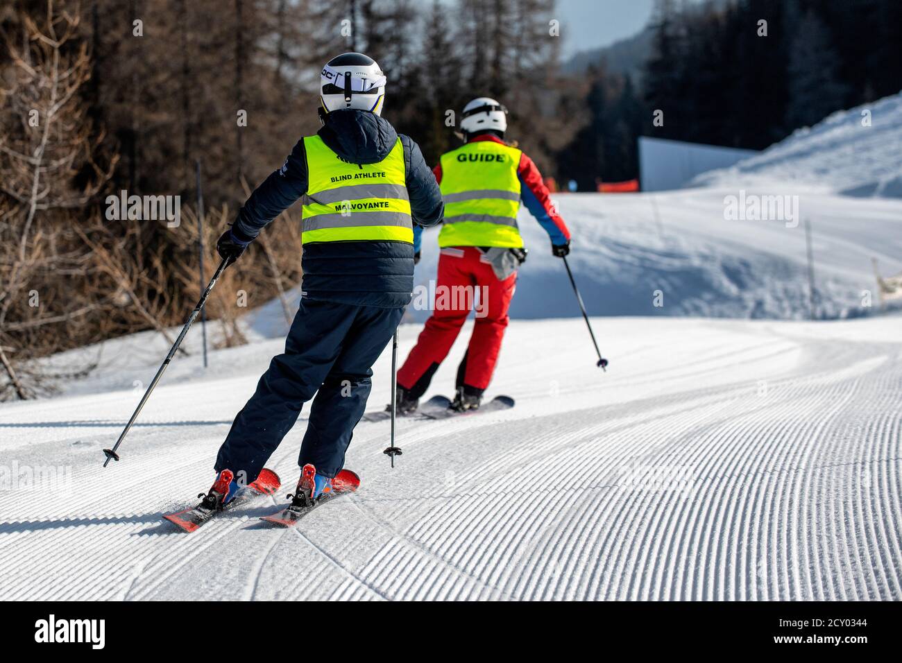 A blind skier follows a guide in the French alpine ski resort of La Plagne. Partially sighted. Stock Photo