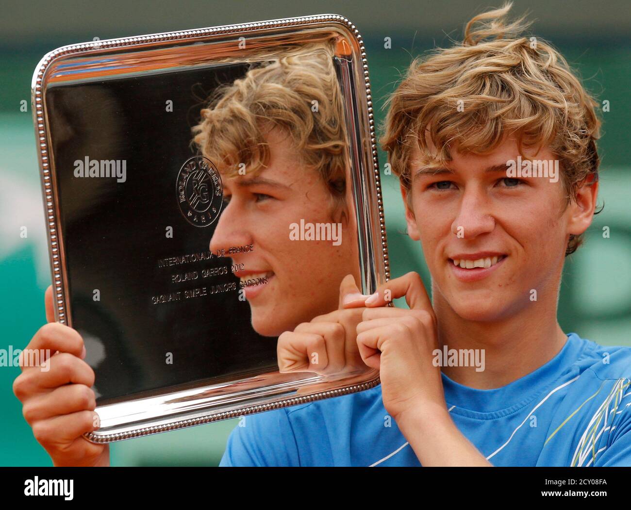 Kimmer Coppejans of Belgium poses with his trophy during a ceremony after  defeating Filip Peliwo of Canadan during their junior boys final at the  French Open tennis tournament at the Roland Garros