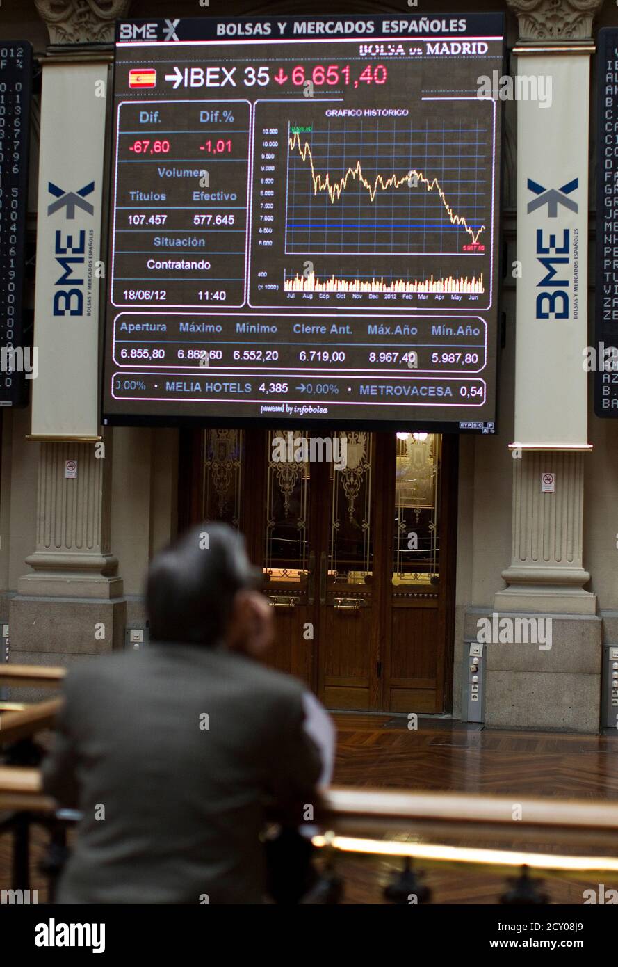 A man looks at the IBEX 35 session on an electronic board at the Madrid stock exchange, June 18, 2012. Spanish bond yields hit a new euro-era high above seven percent and Italian yields jumped on Monday as initial relief after a pro-bailout victory in Greek elections gave way to pessimism about the huge problems still facing the currency bloc.  REUTERS/Paul Hanna  (SPAIN - Tags: BUSINESS) Stock Photo