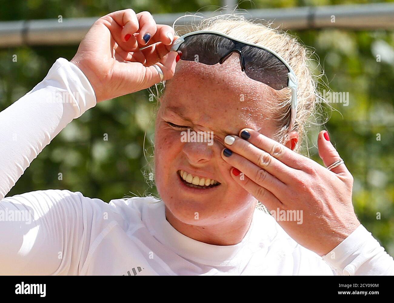 Britain's women's beach volleyball player Shauna Mullin wipes her eye as she trains at the London 2012 Olympics beach volleyball venue in central London July 19, 2012. REUTERS/Suzanne Plunkett (BRITAIN - Tags: SPORT OLYMPICS SOCIETY VOLLEYBALL) Stock Photo