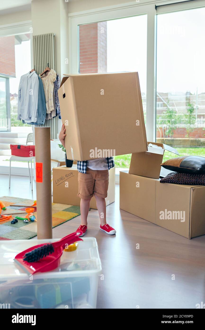 Boy carrying very large moving box Stock Photo