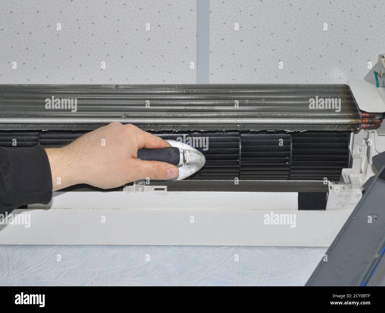 Close up on Air Conditioner Cleaning with Brush Stock Photo