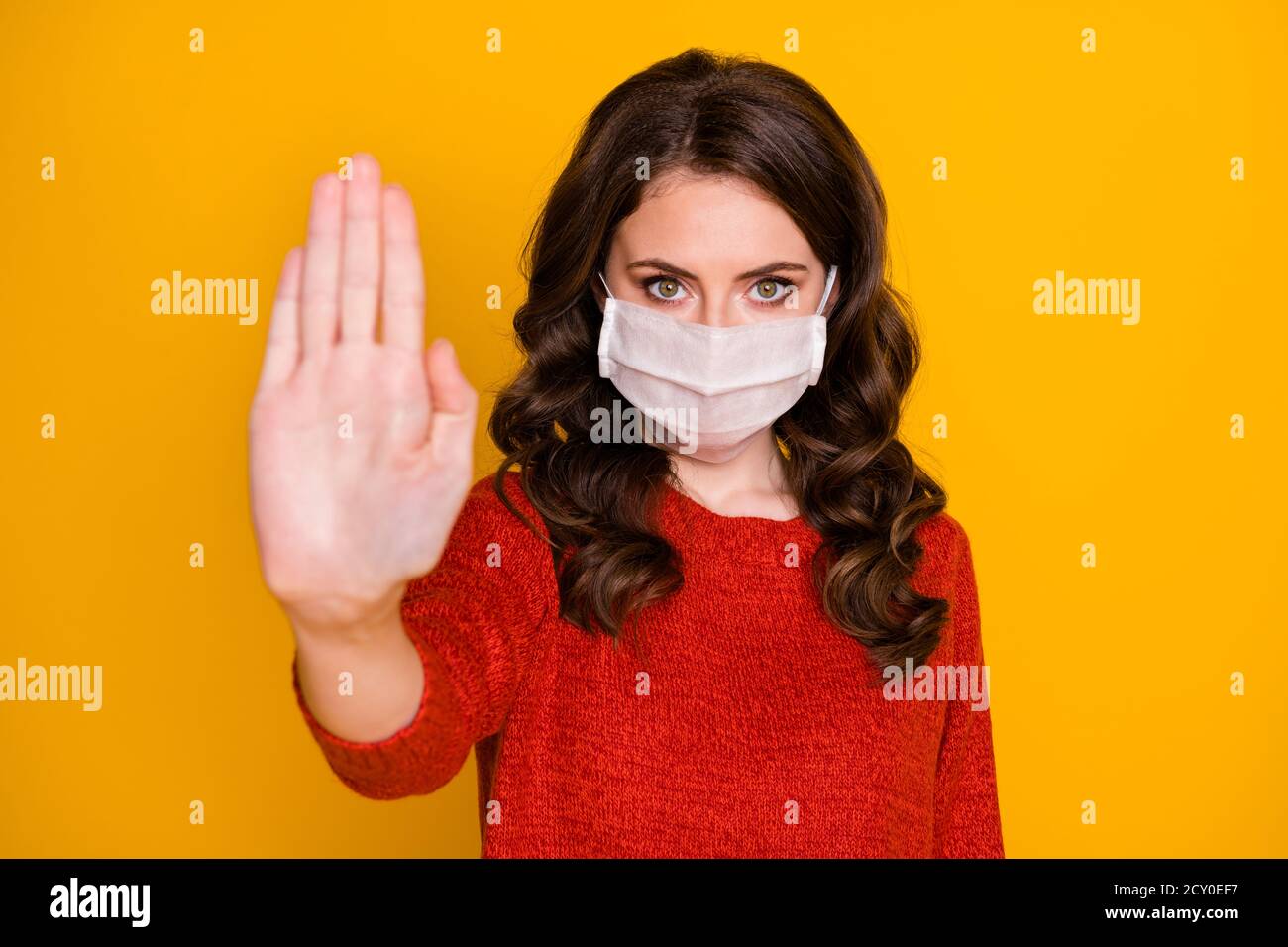 Photo of attractive doctor lady raise arm toward camera express negative attitude social contacting wear casual outfit protective viral mask isolated Stock Photo