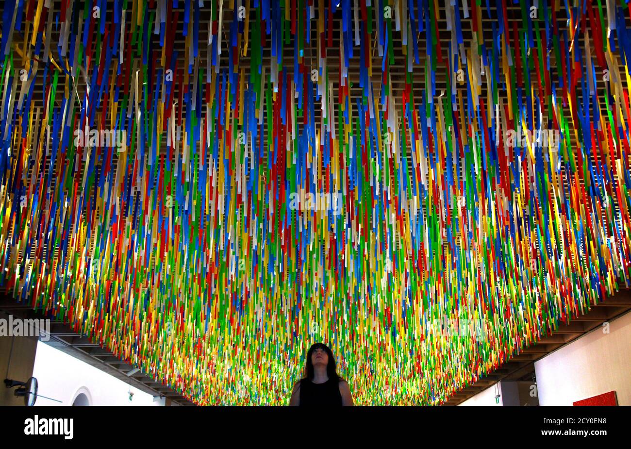 Hospital ekstremt Held og lykke Australian artist Nike Savvas inspects her artwork titled 'Rally' that  hangs from the roof of the New South Wales Art Gallery April 7, 2014.  Savvas says her hanging installation, which is made