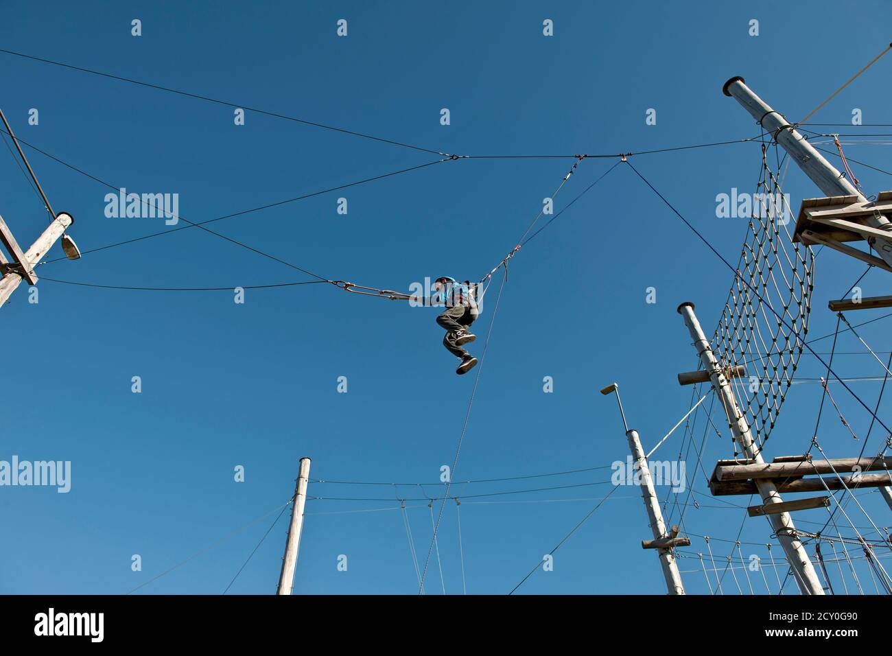 boy on a high swing at high rope access course in Iceland Stock Photo