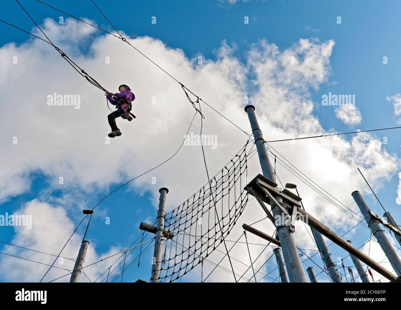 girl on a high swing at high rope access course in Iceland Stock Photo