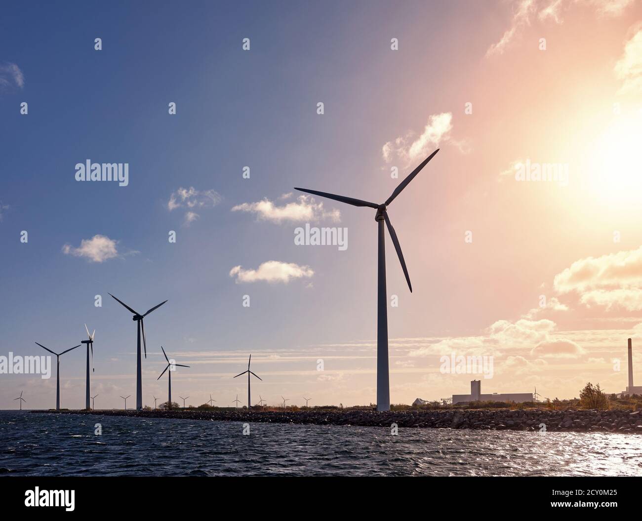 Wind turbines on the coast at sunset, Denmark Stock Photo