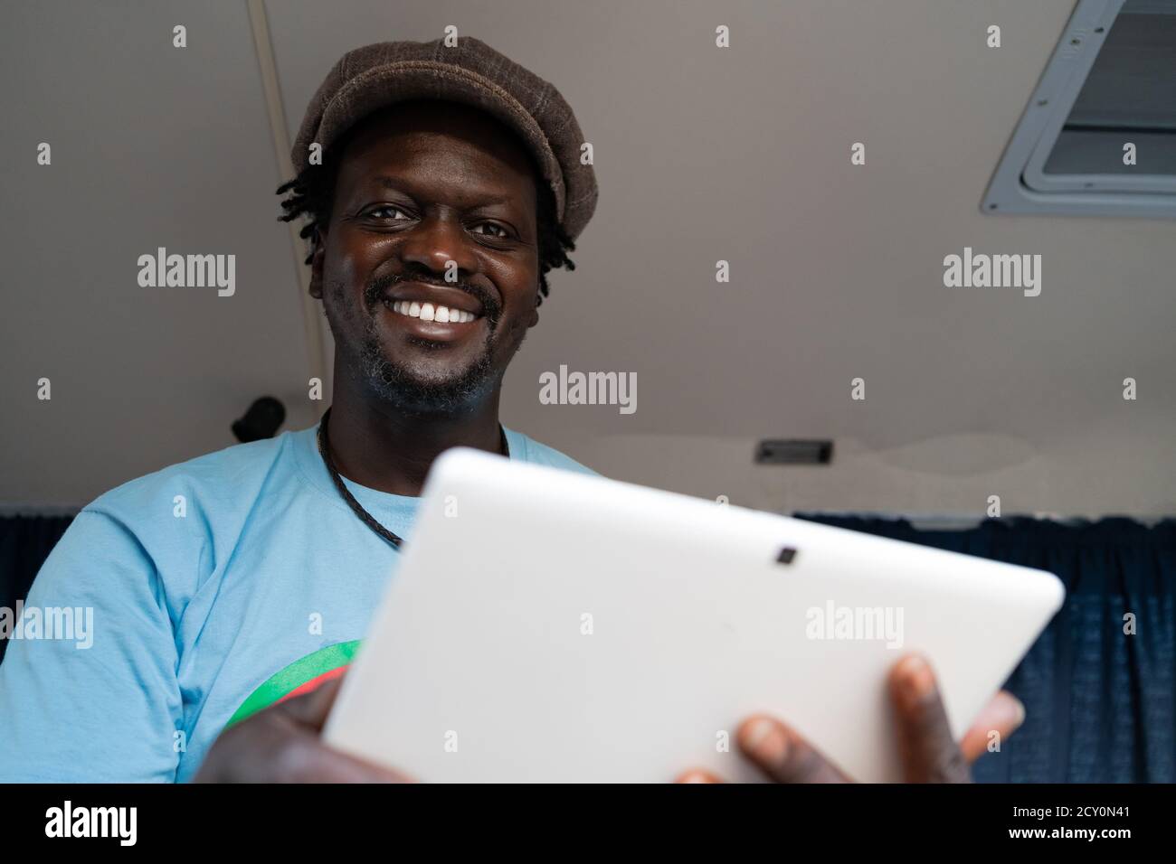 African black boy working with tablet inside a van Stock Photo